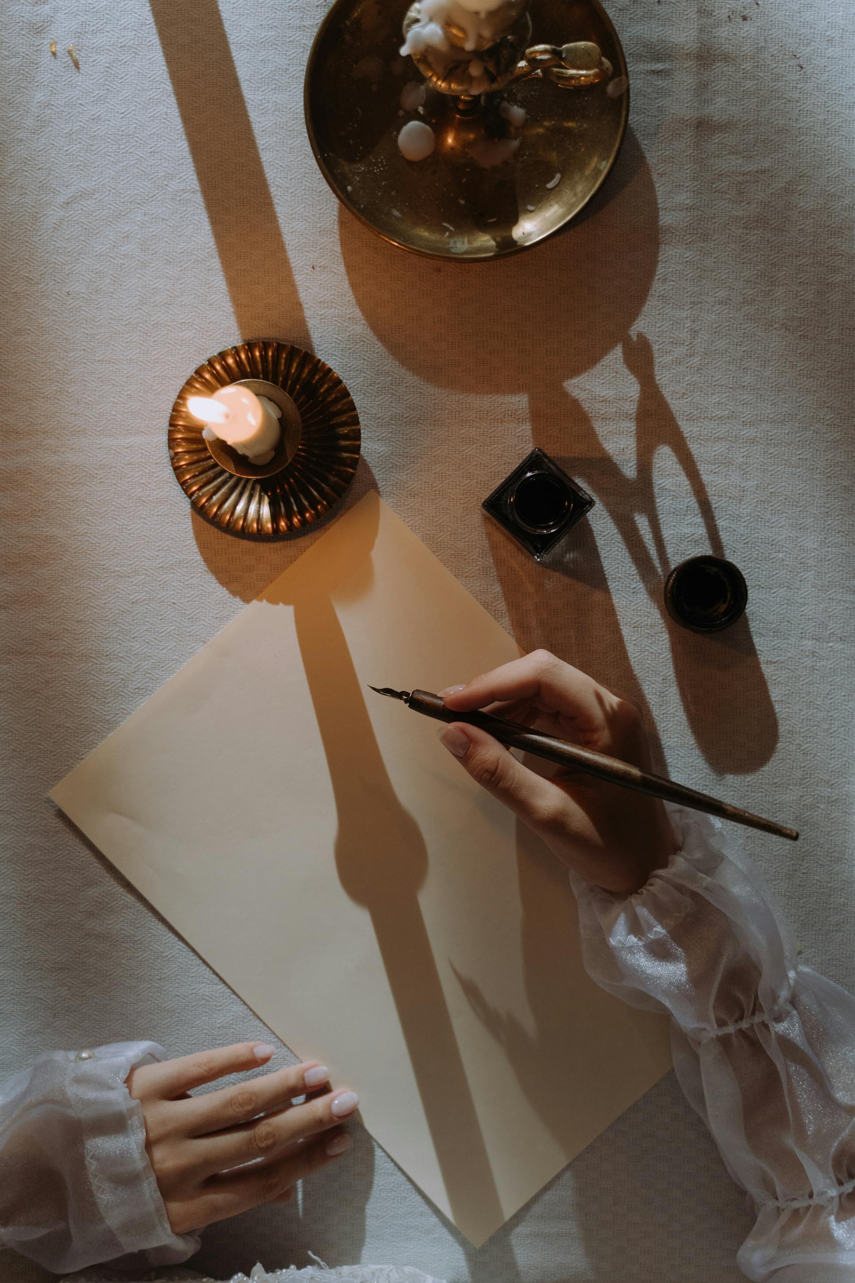 A nostalgic scene of writing with a quill by candlelight, evoking historical charm.